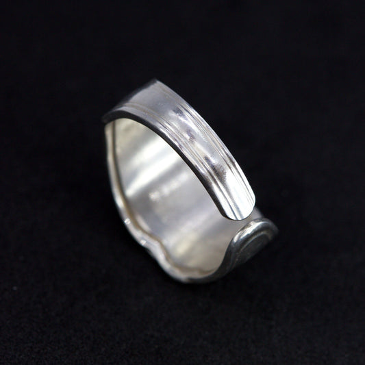 Silver ring on a black background