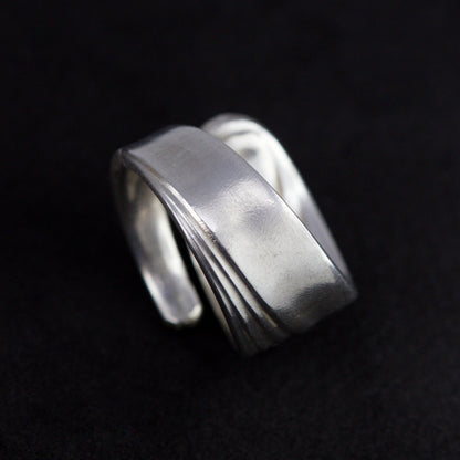 Silver ring on a black background