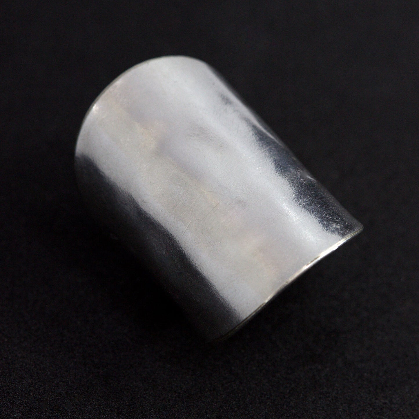 Silver ring on a black background