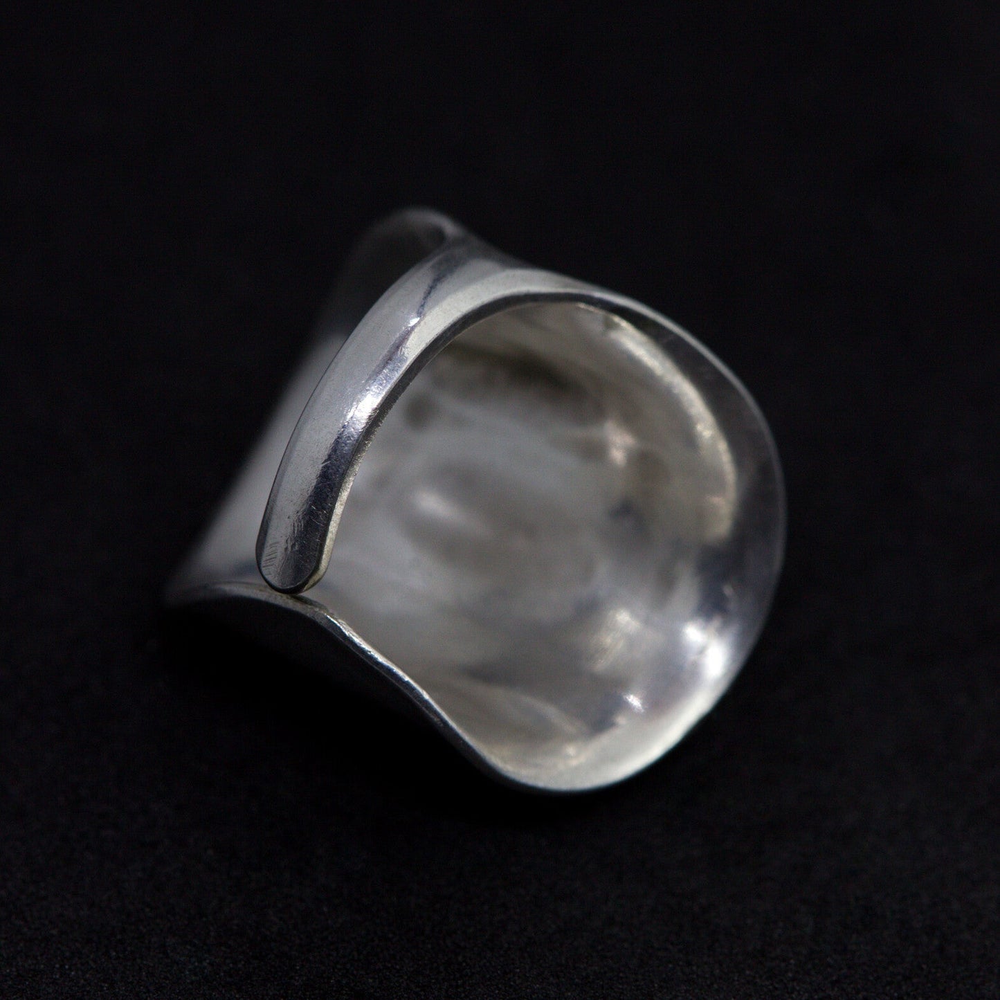 Silver ring on a black background