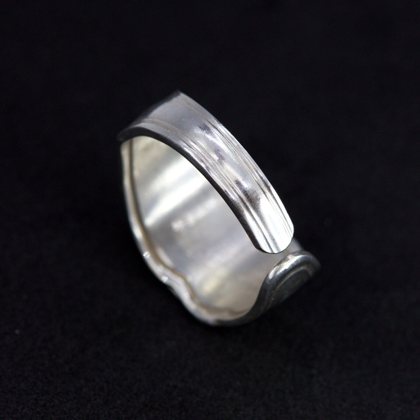 Silver ring on a black background