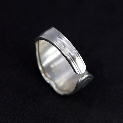 Silver ring on a black background